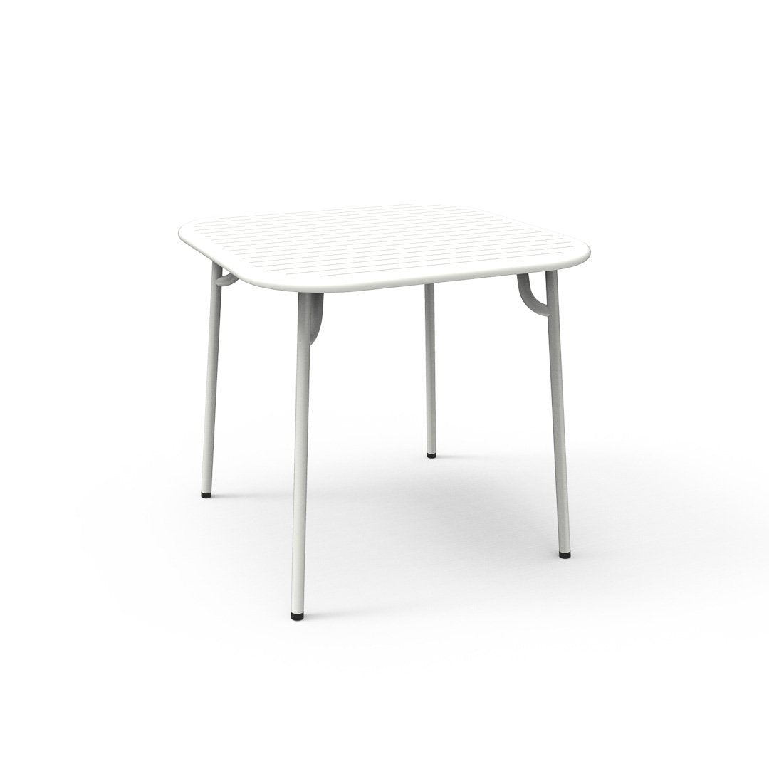 White square table with sleek, minimalist design and silver legs, perfect for modern decor.