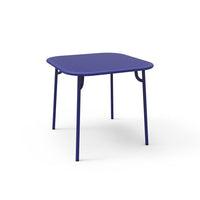 Square purple table with a smooth surface and sleek metal legs, perfect for modern decor. Ideal for indoor or outdoor use.