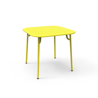 Bright yellow square table with a smooth surface and sleek, minimalistic design, perfect for modern spaces.