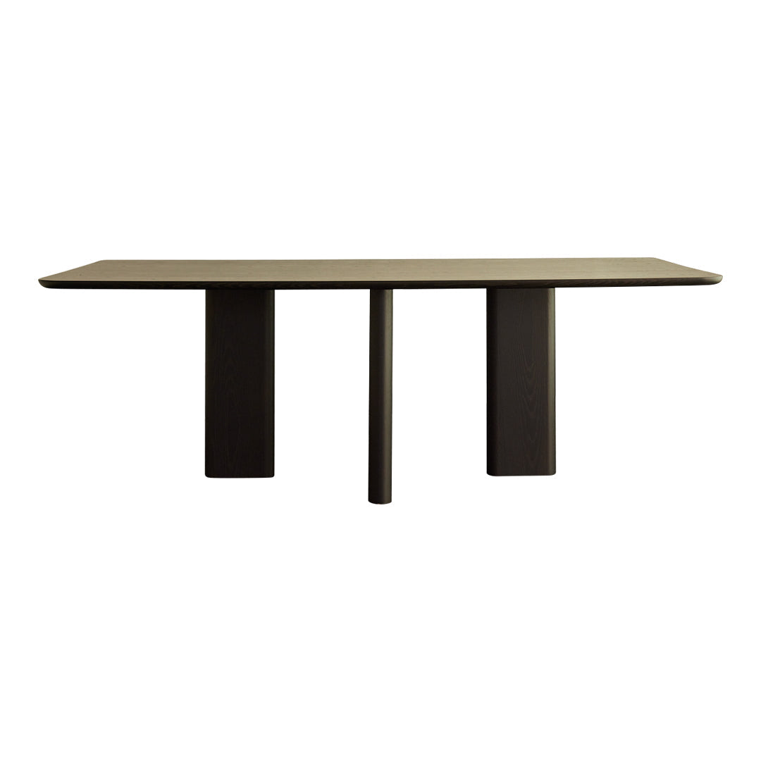 Sleek black dining table with a smooth, matte finish and minimalist geometric design.