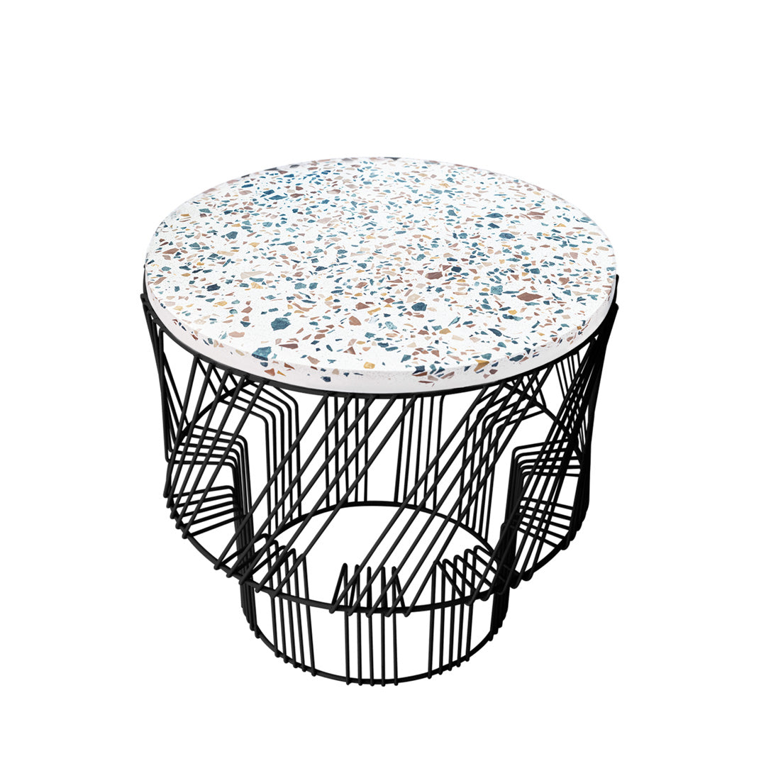 Round coffee table with a speckled white top featuring blue and orange accents, supported by a sleek black wire frame.