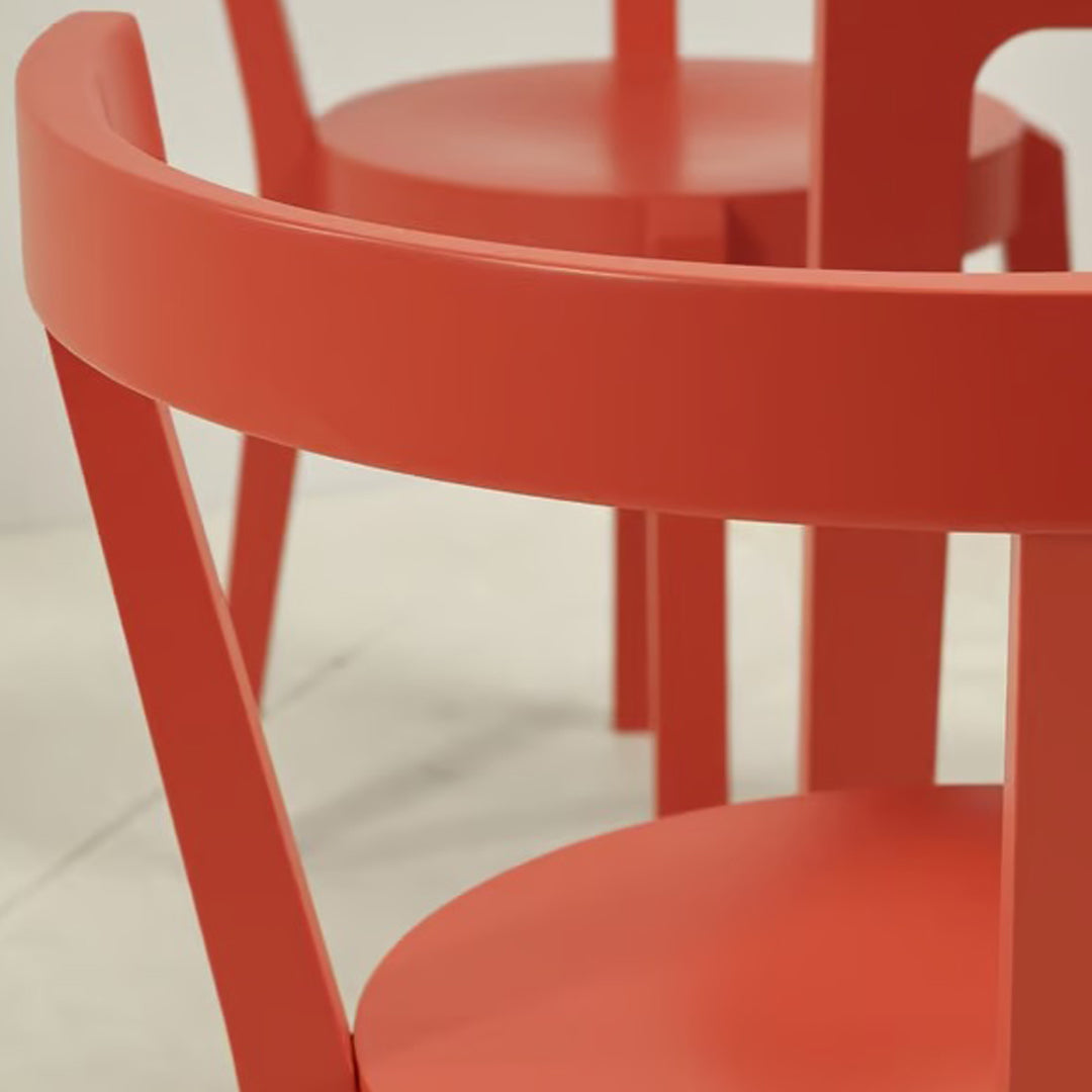 Vibrant orange wooden chair with a smooth finish and modern design, featuring a simple, clean pattern.
