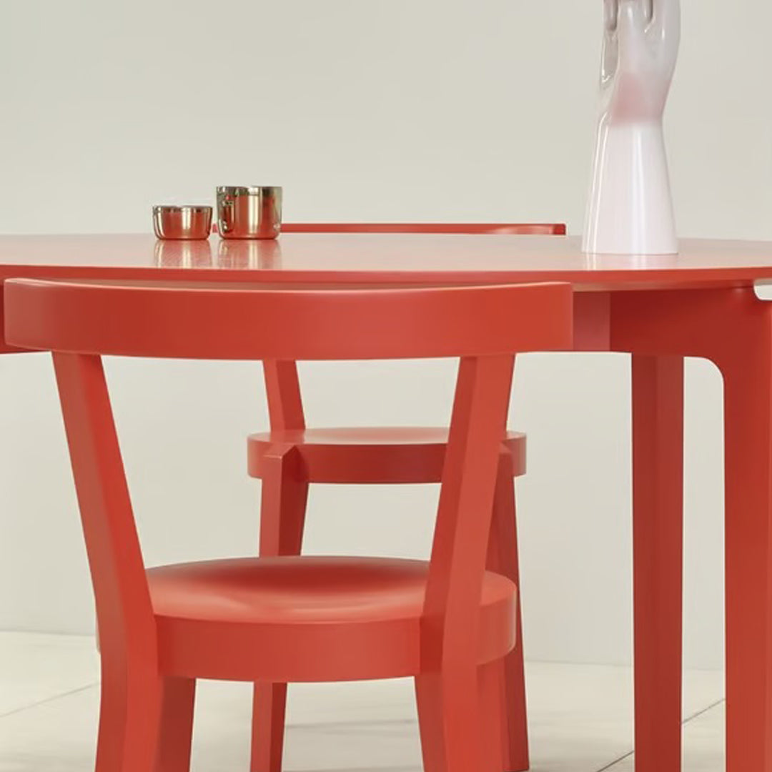 Bright red table and matching chair with a sleek, minimalist design. Perfect for modern interiors.