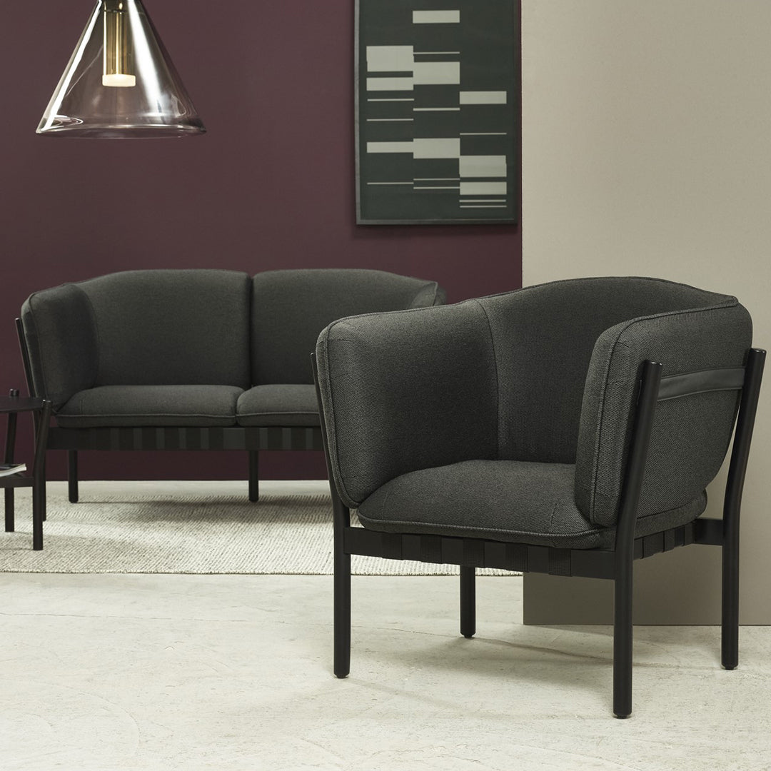 Modern black sofa set with a sleek, minimalist design and textured gray upholstery. Perfect for contemporary decor.