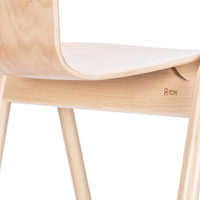 Light wood chair with a smooth natural finish and minimalist design, featuring a simple curved seat and tapered legs.
