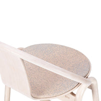 Light beige chair with a speckled tan and blue patterned seat, featuring a minimalist design.