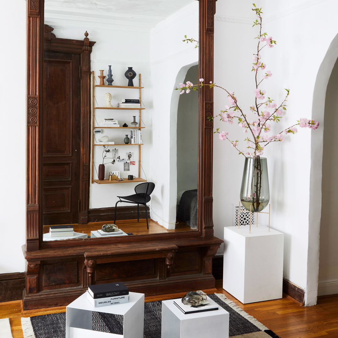Stylish black and white geometric pattern on modern decor with warm wooden accents and soft pink floral elements.