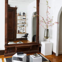 Stylish black and white geometric pattern on modern decor with warm wooden accents and soft pink floral elements.