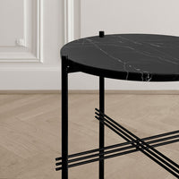 Black round marble tabletop with white veining on a sleek black metal frame. Modern and elegant design.