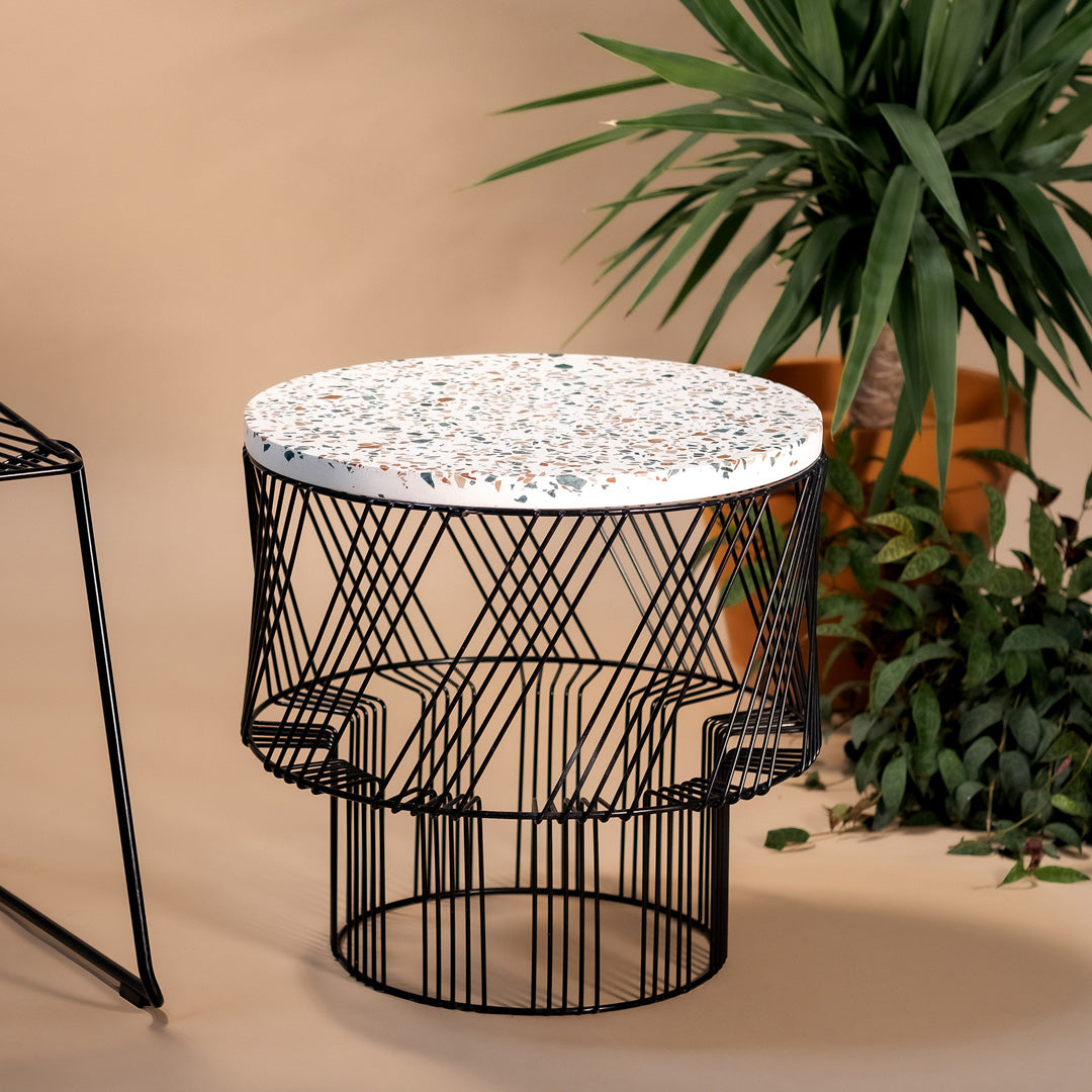 Round white mosaic tabletop with black wire base, featuring geometric patterns and modern design elements.