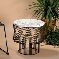 Round white mosaic tabletop with black wire base, featuring geometric patterns and modern design elements.