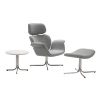 Modern gray upholstered chair, matching ottoman, and sleek white side table with minimalist chrome legs.
