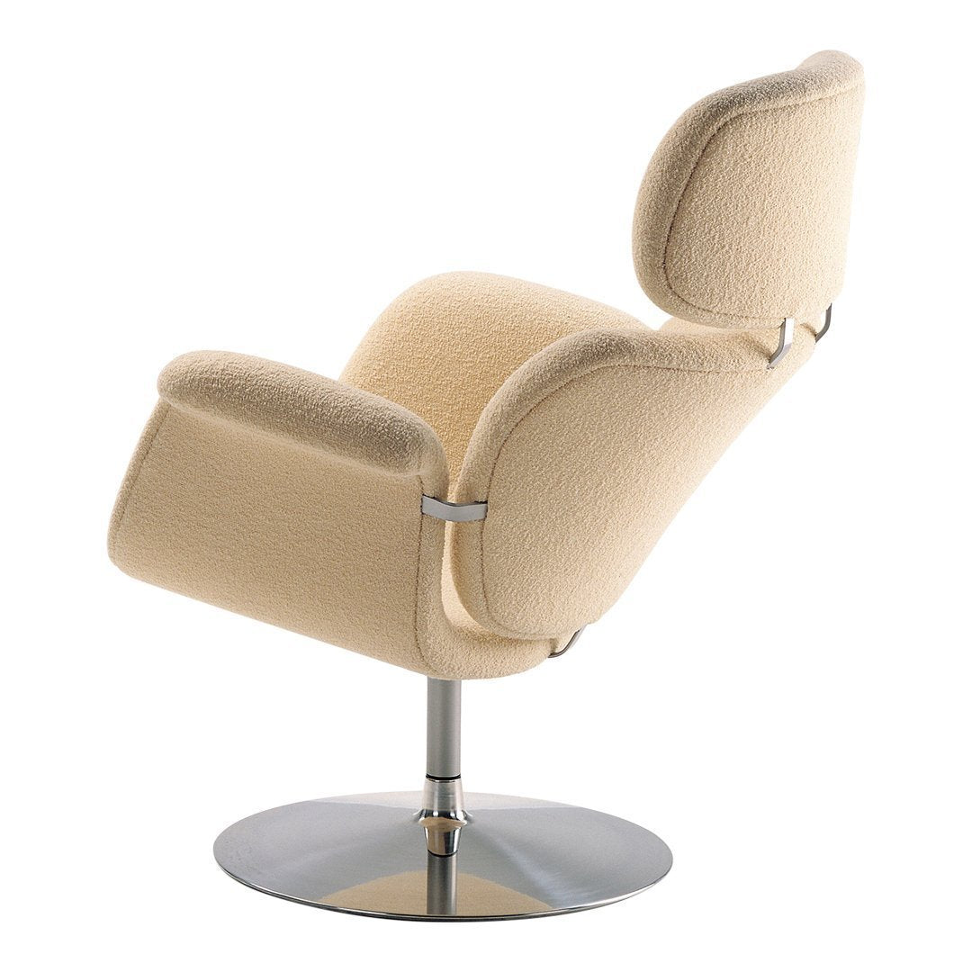 Cream-colored modern chair with soft texture and smooth, sleek chrome base. Stylish and contemporary design.