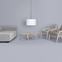 Modern gray sofa, light gray chairs, and a white pendant lamp against a soft gray backdrop. Clean lines and minimalist design.