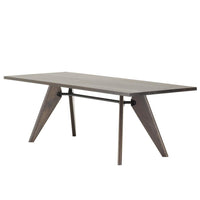 Modern wood dining table with a sleek gray finish and angular, geometric legs for a stylish touch.