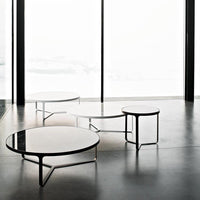 Modern coffee tables in glossy black and white, featuring sleek lines and minimalist design.