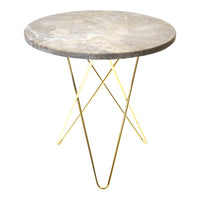 Round gray marble table with sleek gold metal legs, featuring a minimalist design and smooth surface.