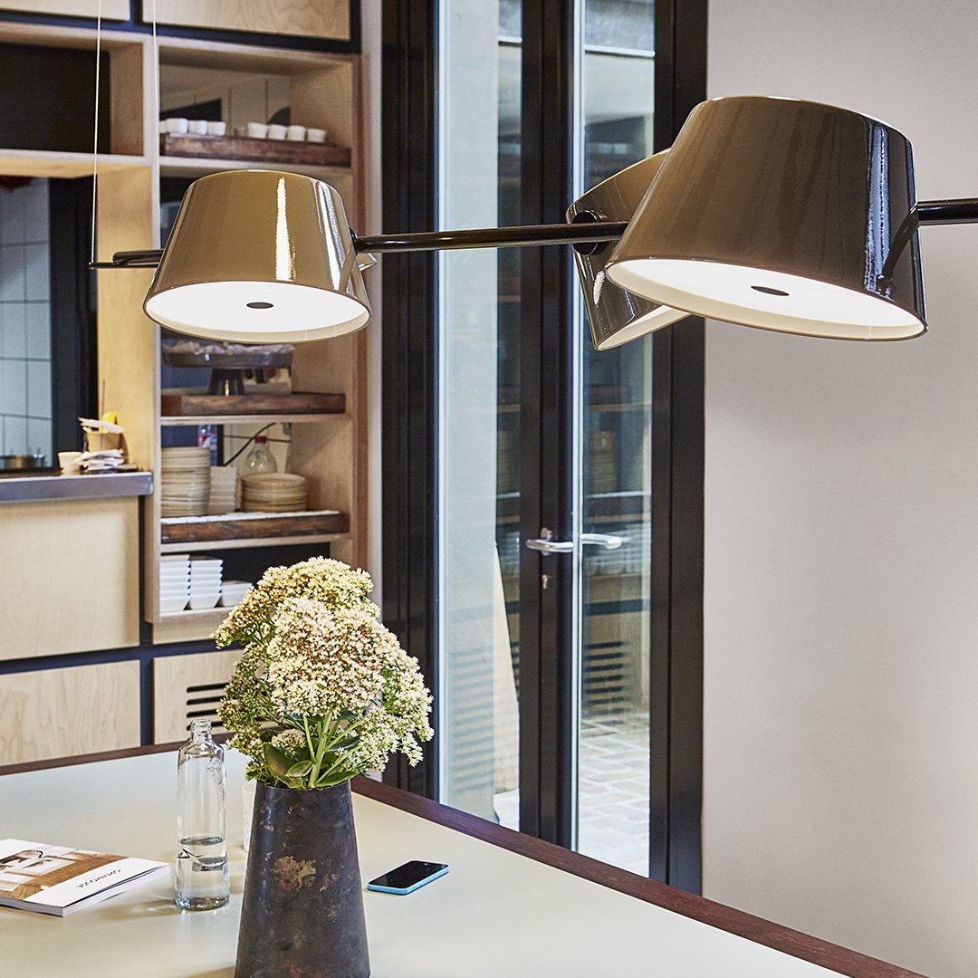 "Stylish brown and white pendant lamps with a sleek modern design against a neutral backdrop."
