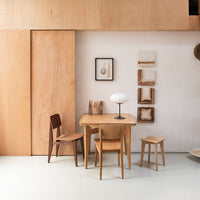 Light wood dining set featuring natural grain patterns against a minimalist white backdrop. Elegant and modern design.