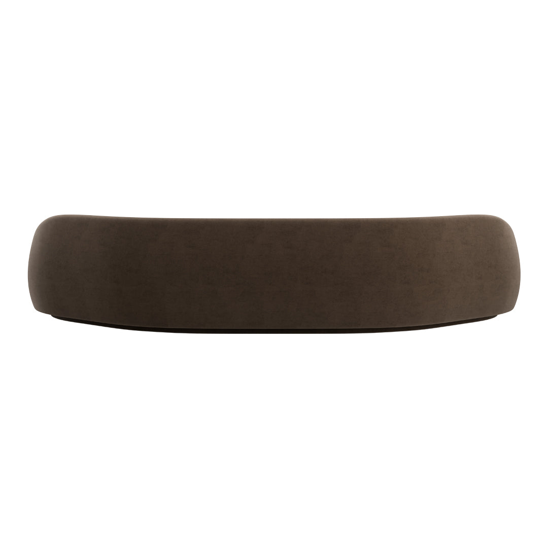 Brown curved sofa with a soft, textured fabric finish, adding a modern touch to any living space.