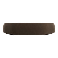 Brown curved sofa with a soft, textured fabric finish, adding a modern touch to any living space.