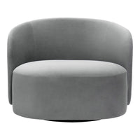 Round gray accent chair in soft velvet. Smooth, modern design with subtle curves and a sleek finish. Perfect for any space.