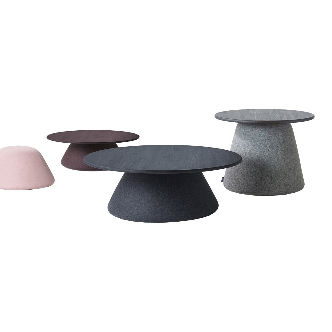 "Set of modern coffee tables in pink, dark gray, and light gray, featuring sleek, minimalist designs and varied shapes."