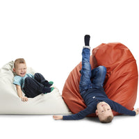 "White and orange bean bags featuring smooth textures, ideal for playful seating for kids."