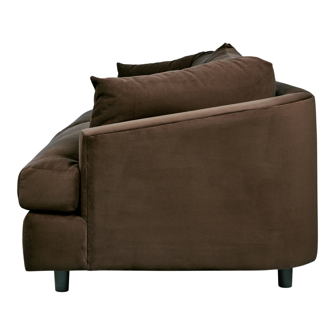 Brown upholstered sofa with a smooth, velvety texture and plush pillows, featuring a sleek, modern design.