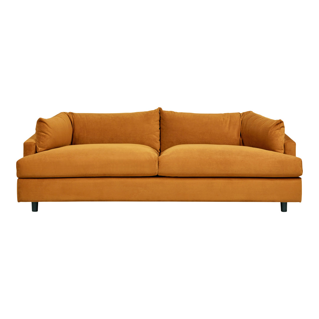 Velvet mustard-yellow sofa with modern design; features solid color and plush cushions for comfort.