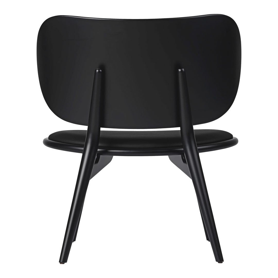 Black chair with a smooth finish and minimalist design, featuring sleek lines and a modern silhouette.