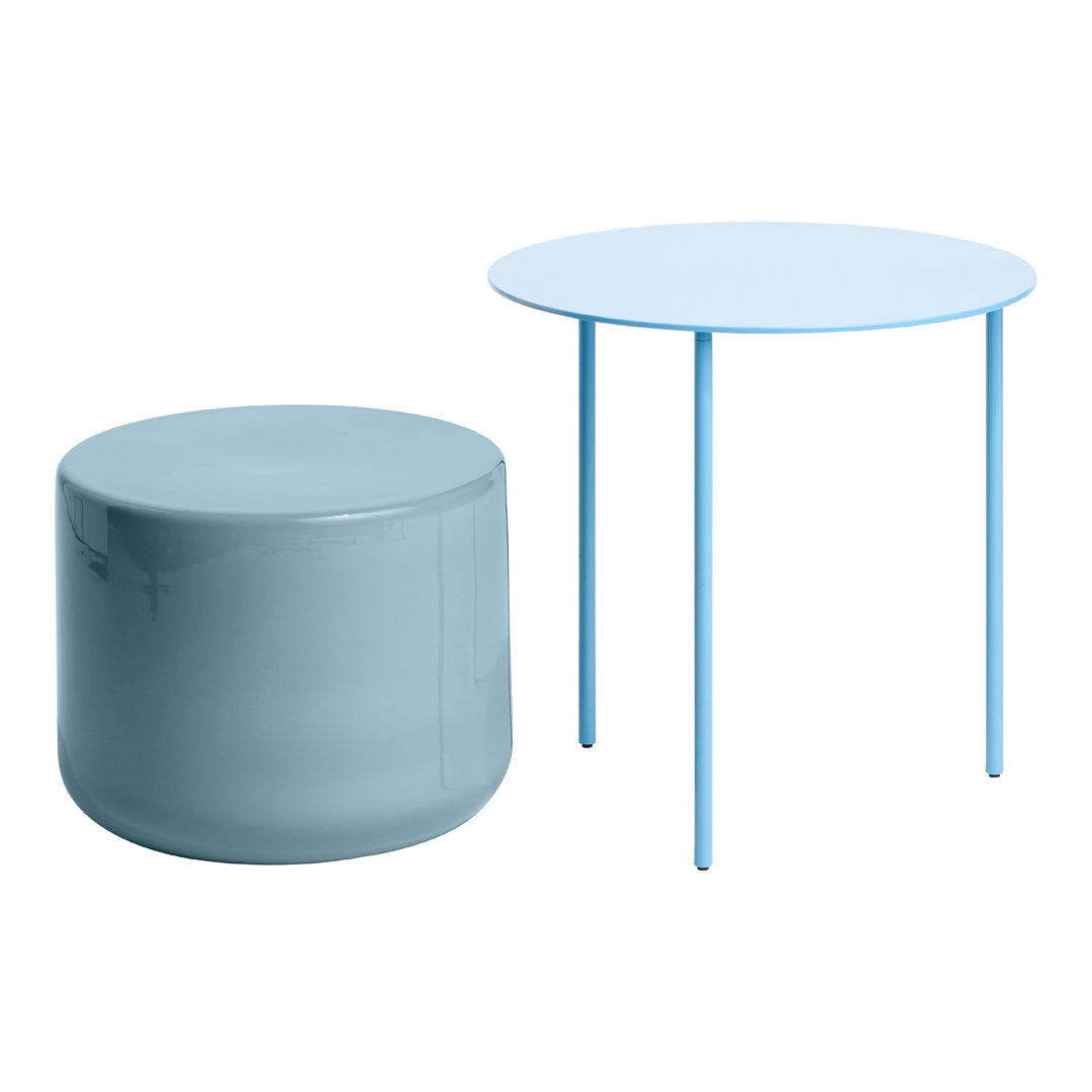 Light blue round table and soft blue cylindrical stool, featuring smooth, modern surfaces for a minimalist aesthetic.