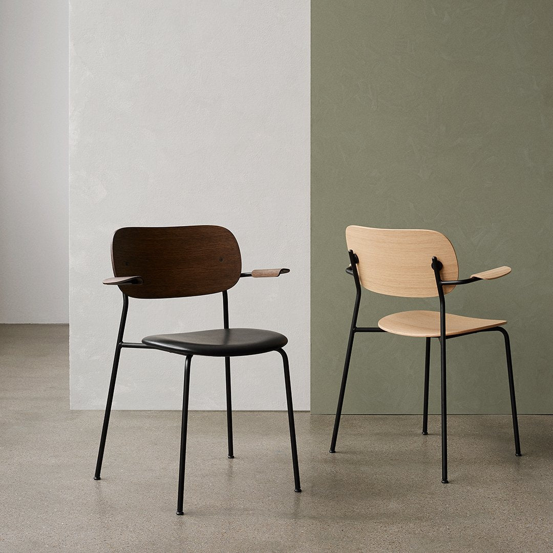 "Two modern chairs: one in dark wood and black, the other in light wood against neutral and green backgrounds."