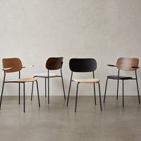 Set of four modern chairs featuring natural wood tones and sleek black metal accents. Unique shapes and minimalist design.