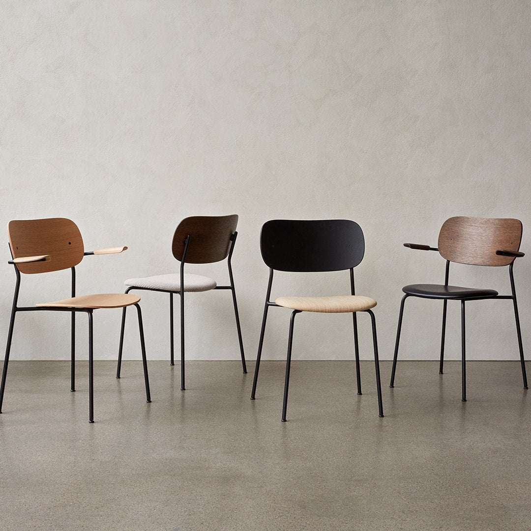 Set of four modern chairs featuring black, brown, and natural wood finishes with minimalist design.