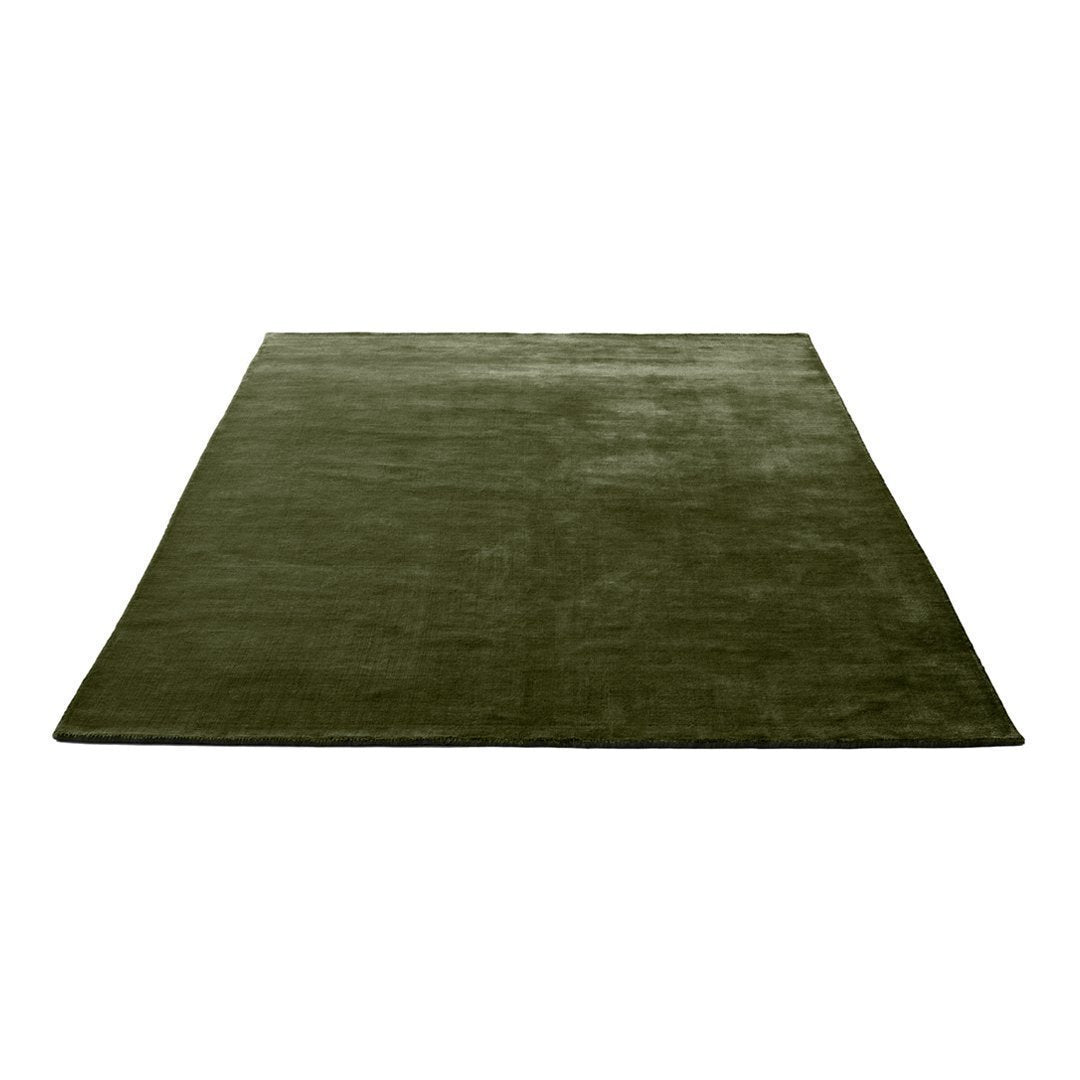 Solid deep olive green area rug with a smooth texture, perfect for adding warmth to any space.