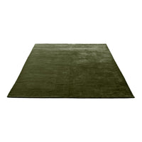 Solid deep olive green area rug with a smooth texture, perfect for adding warmth to any space.