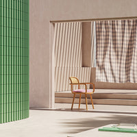 "Modern interior featuring green tiles, beige walls, and a checked curtain in soft brown and cream tones."