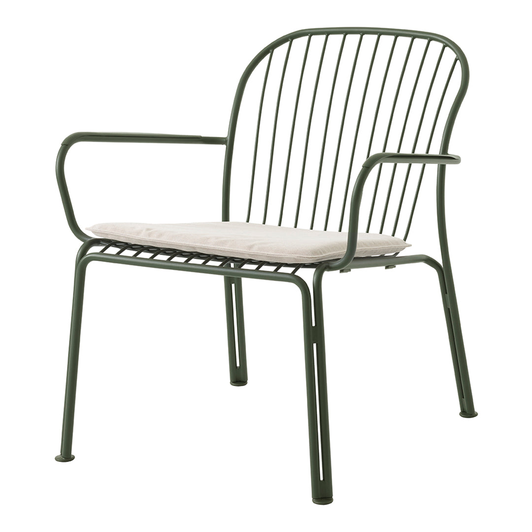 Green metal chair with vertical stripes and a neutral-colored cushion. Modern and minimalistic design.