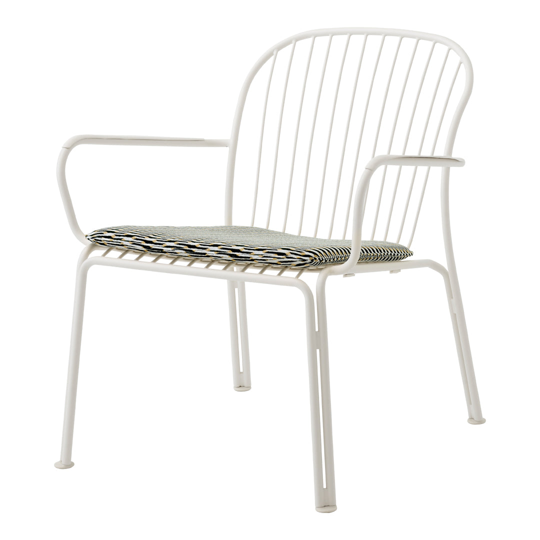 White metal chair with a striped green and black cushion, featuring a modern, minimalist design.