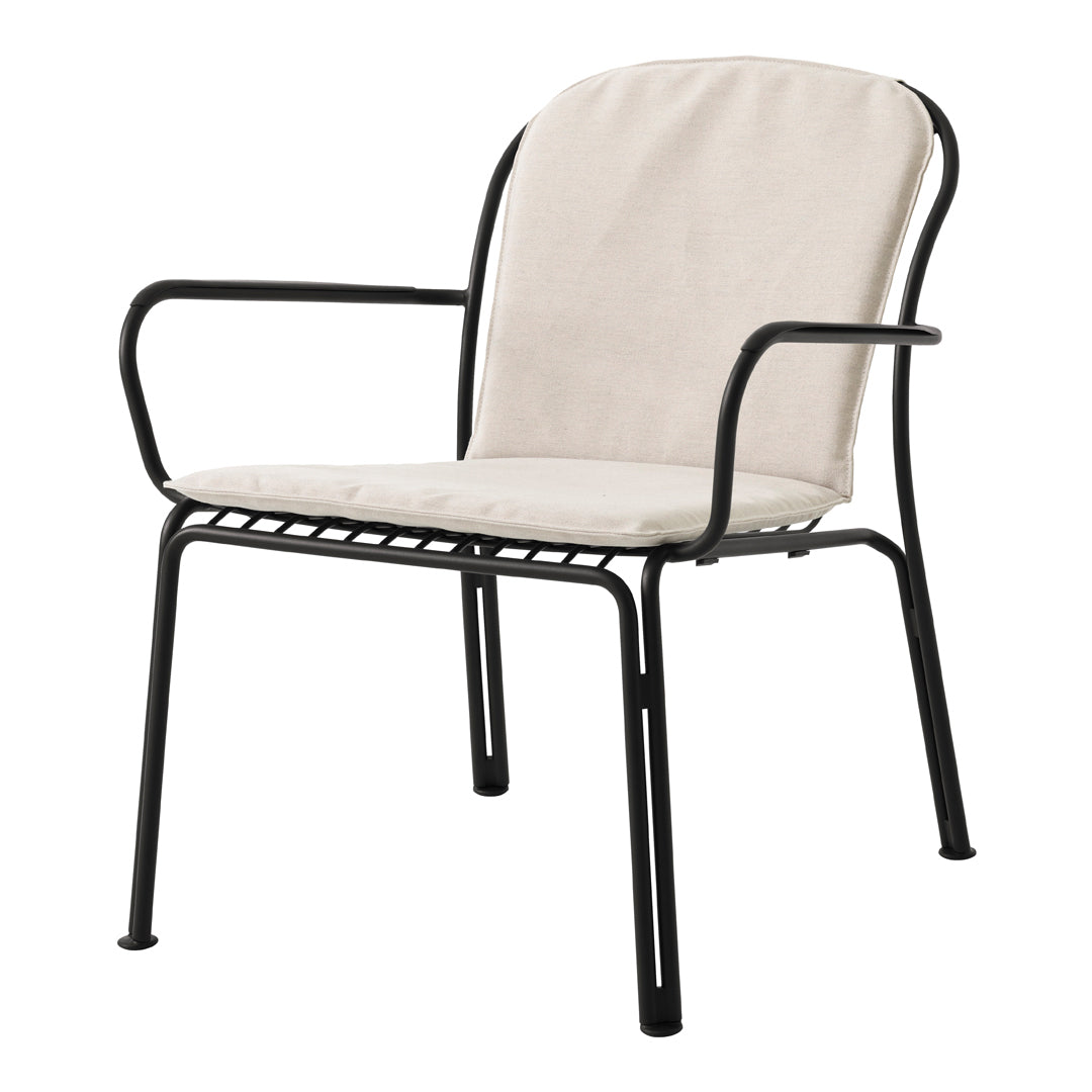 Beige cushioned armchair with a sleek black metal frame, featuring a minimalist design and clean lines.