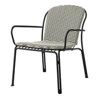 Patterned chair featuring a zigzag design in muted greens, blacks, and whites on a sleek black metal frame.