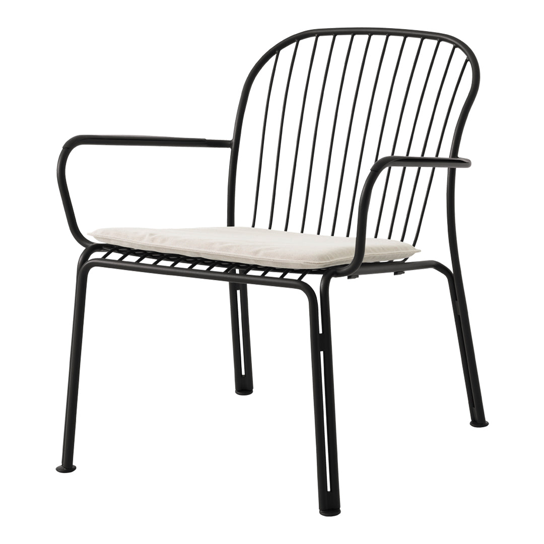 Black metal chair with a sleek design and light beige cushion, featuring minimalist lines and open patterns.