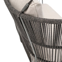 Gray woven chair with a natural fabric cushion, featuring vertical stripes and a modern design.
