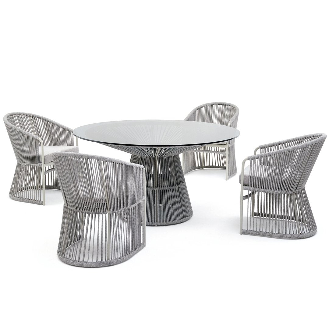 Gray round dining table with four matching chairs featuring a sleek, modern stripe pattern. Stylish and contemporary design.