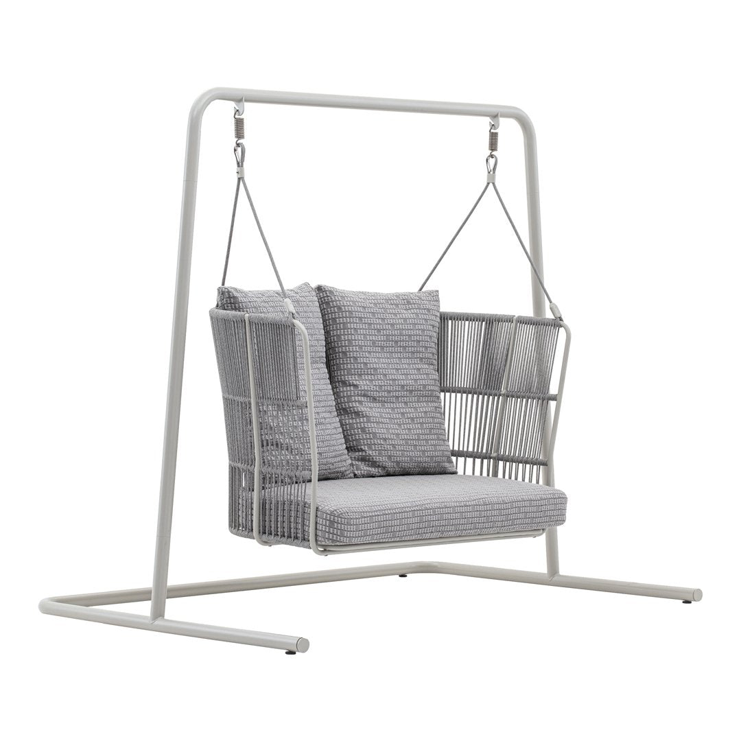 Gray patterned cushions on a white metal swing chair with a minimalistic design. Perfect for outdoor relaxation.