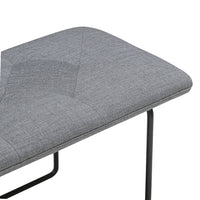 Gray upholstered bench with a textured pattern, featuring sleek black legs. Perfect for modern decor.