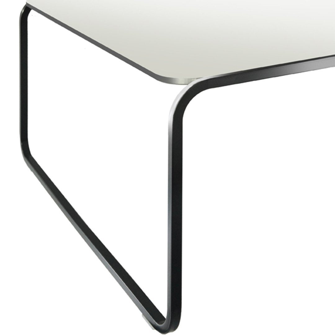 Modern black and white table featuring a sleek, minimalist design with smooth lines and a glossy finish.