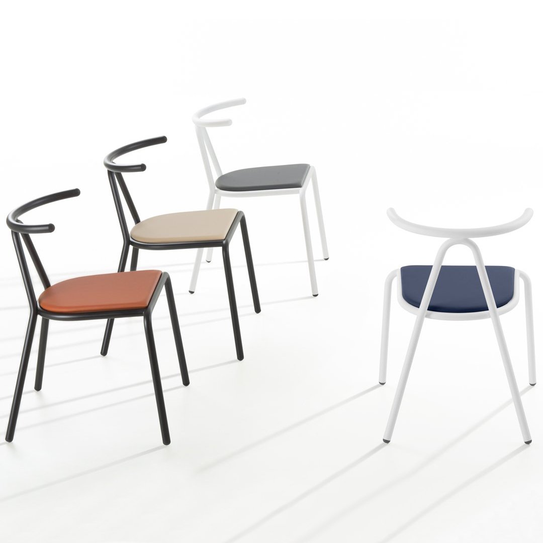 "Modern chairs in brown, beige, gray, and navy with sleek black and white frames, showcasing diverse colors and patterns."