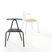 "Black and white chairs with wooden seat, showcasing modern design and minimalist style against a bright background."